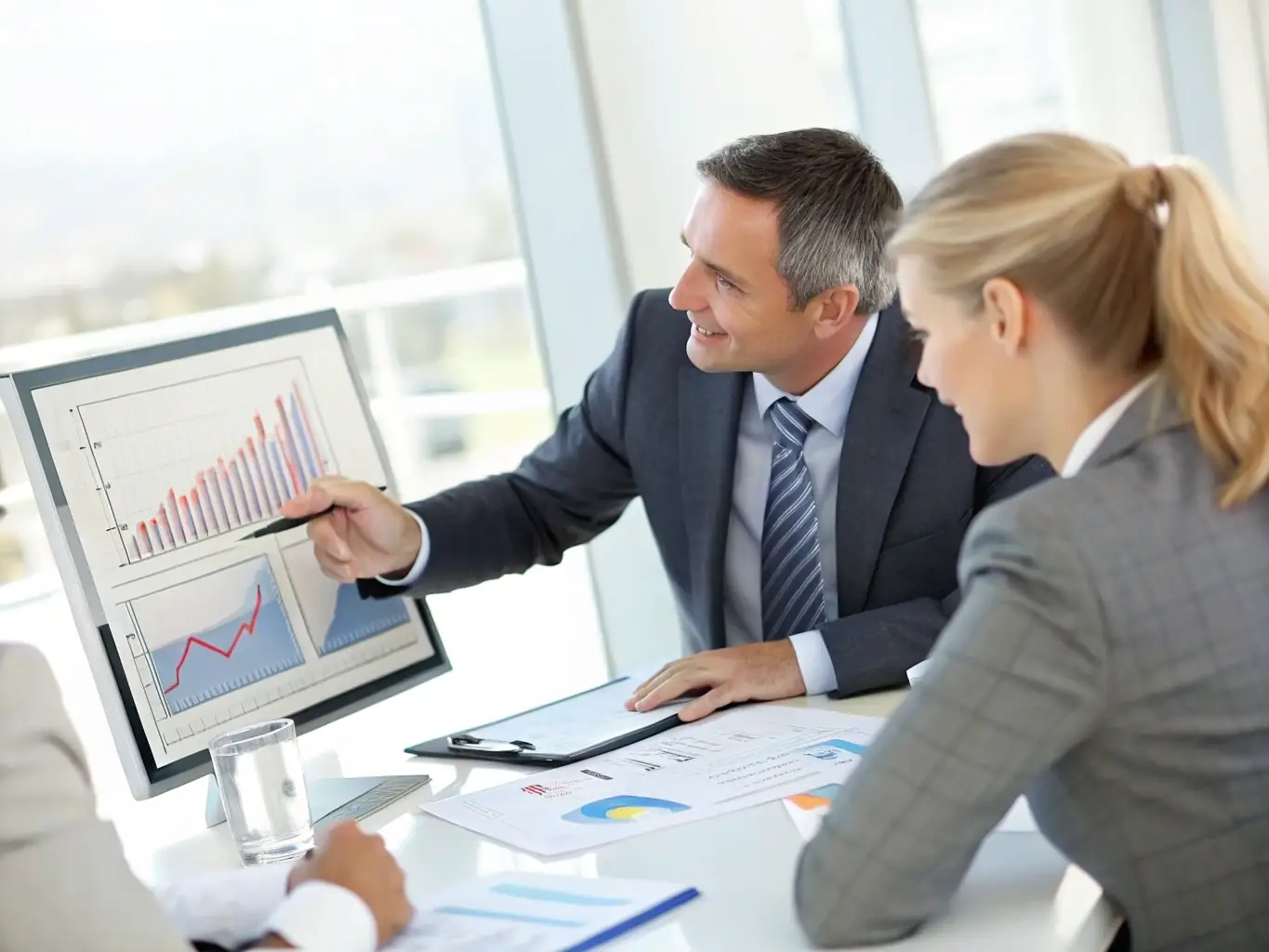 A consultant is presenting a data-driven report to a client, highlighting key performance indicators and strategic insights for business growth.